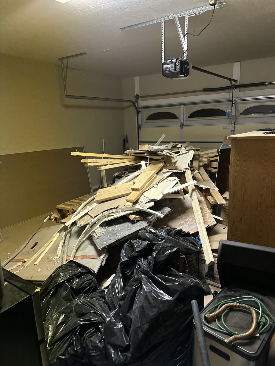 Before — garage packed with demolition debris